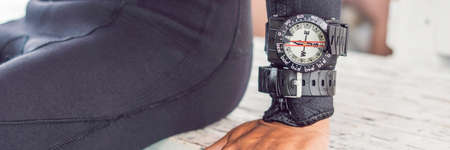Young diver preparing an underwater compass for diving. BANNER, long format