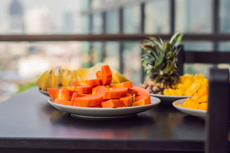 Breakfast table with coffee fruit and bread croisant on a balcony against the backdrop of the big...