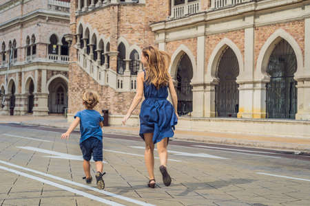 Mom and son on background of Sultan Abdul Samad Building in Kuala Lumpur, Malaysia. Traveling with children concept.の写真素材