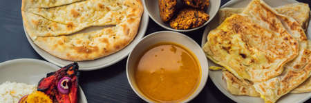 Assorted indian food on dark wooden background. Dishes and appetizers of indian cuisine. Curry,...