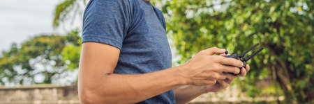 Man holds remote controller with his hands and controls the drone. New technologies and innovations...