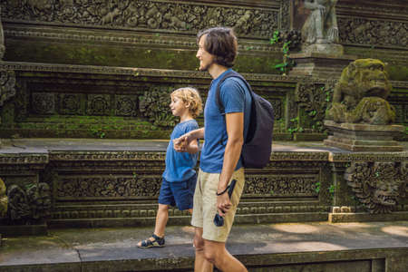 Dad and son travelers discovering Ubud forest in Monkey forest, Bali Indonesia. Traveling with children concept.の写真素材