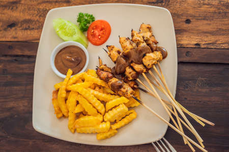 Chicken satay served with peanut sauce and french fries. Bali, Lifestyleの写真素材