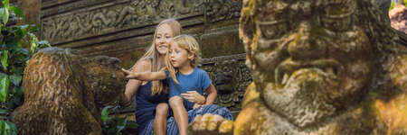 Mom and son travelers discovering Ubud forest in Monkey forest, Bali Indonesia. Traveling with children concept. BANNER, long formatの写真素材