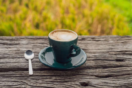 A cup of coffee on the of an old wooden table. A heart for coffee. St. Valentine's Day concept.