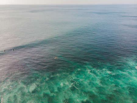Surfers on the waves in the ocean, top view.の写真素材
