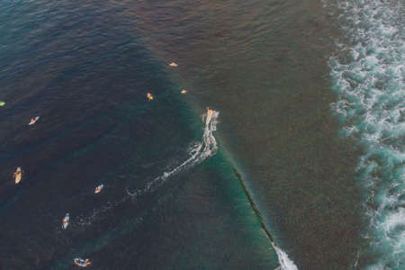 Surfers on the waves in the ocean, top view.の写真素材