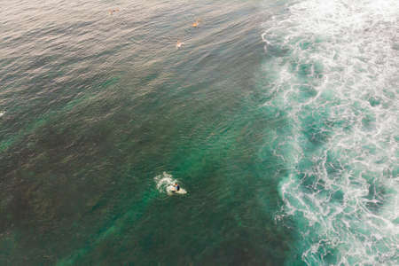 Surfers on the waves in the ocean, top view.の写真素材