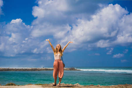 Young woman traveler on amazing Melasti Beach with turquoise water, Bali Island Indonesia.の写真素材