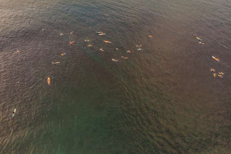 Surfers on the waves in the ocean, top view.の写真素材
