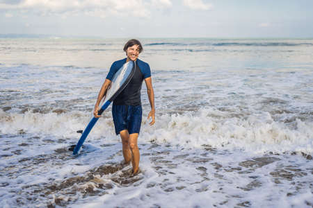 Man carrying surfboard