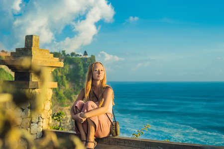 Young woman traveler in Pura Luhur Uluwatu temple, Bali, Indonesia.の写真素材