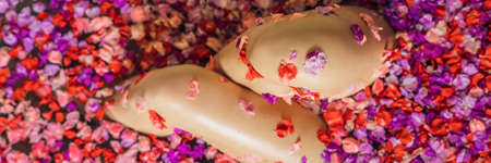 Attractive Young woman in bath with petals of tropical flowers and aroma oils.の写真素材