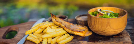 French fries, green salad with champignons and chicken breast.の写真素材