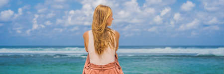 Young woman traveler on amazing Melasti Beach with turquoise water, Bali Island Indonesia.の写真素材