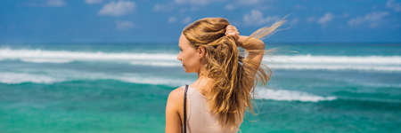 Young woman traveler on amazing Melasti Beach with turquoise water, Bali Island Indonesia.の写真素材