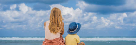 Mom and son travelers on amazing Melasti Beach with turquoise water, Bali Island Indonesia.の写真素材