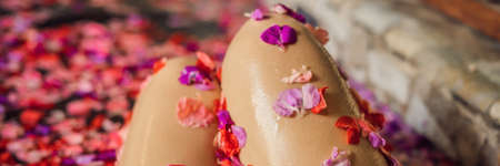 Attractive Young woman in bath with petals of tropical flowers and aroma oils.の写真素材