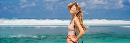 Young woman traveler on amazing Melasti Beach with turquoise water, Bali Island Indonesiaの写真素材