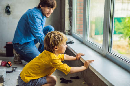Father and son repair windows together. Repair the house yourself.