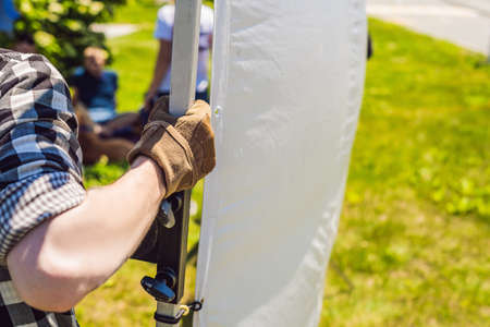 Grip team, light depurtment members prepare the lighting equipment before shooting.の写真素材