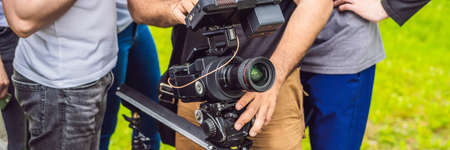 a cameraman operator discuss the shooting process with a director and dp. BANNER, long format