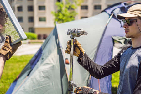 Grip team, light depurtment members prepare the lighting equipment before shootingの写真素材