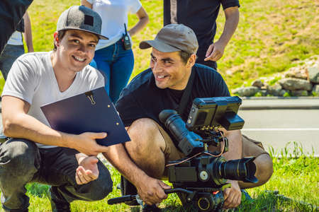 A cameraman operator discuss the shooting process with a director and dp