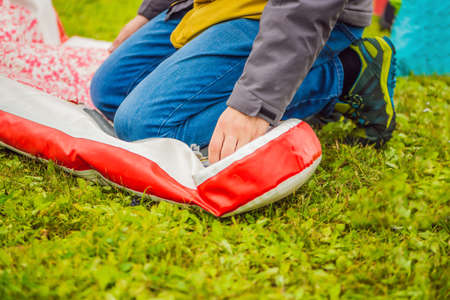 A man blows and collapses SUP A man blows and collapses SUP. Leisure and outdoor sports concept.の写真素材