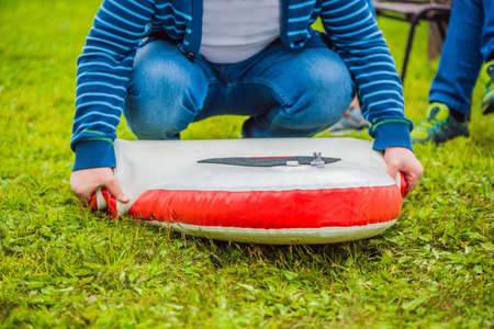 A man blows and collapses SUP A man blows and collapses SUP. Leisure and outdoor sports concept.