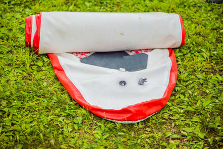 A man blows and collapses SUP A man blows and collapses SUP. Leisure and outdoor sports concept.