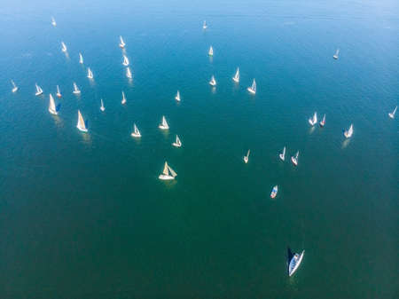 Sailboat shot from above showing the clear blue water of the oceanの写真素材