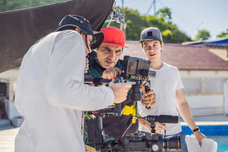 Steadicam operator and his assistant prepare camera and 3-axis stabilizer-gimbal for a commercial...
