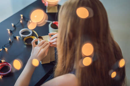 Young woman is packing presents.の写真素材