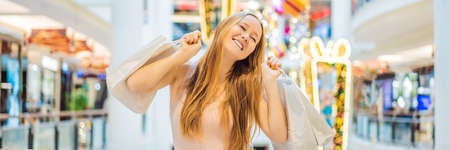 Young woman with purchases in new year shop. Christmas sale, black friday
