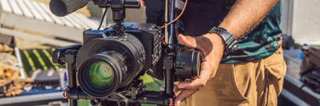 Steadicam operator prepare camera and 3-axis stabilizer-gimbal for a commercial shoot