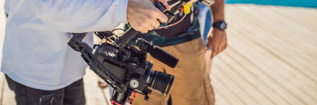 Professional Steadicam operator uses a 3-axis camera stabilizer system on a commercial production...