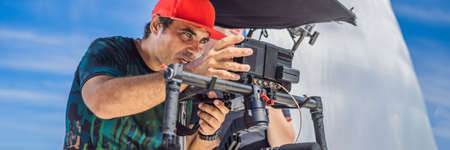 the production team on a commercial video shoot. Steadicam operator uses the 3-axis camera...