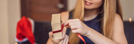 Young woman is packing presents.の写真素材