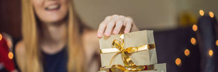 Young woman is packing presents.