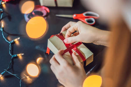 Young woman is packing presents.