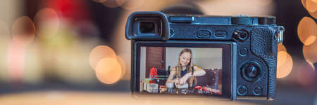 Female video blogger records video about Christmas gifts.