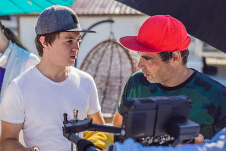 Camera operator, director of photography and director discuss the process of a commercial video...