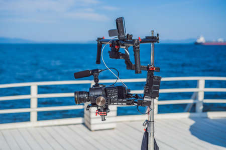 Professional cinema camera on a 3-axis camera stabilizer system on a commercial production setの写真素材