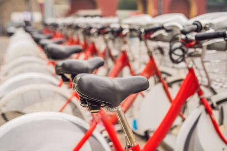 City bicycles for rent stand in a row on a cobbled streetの写真素材