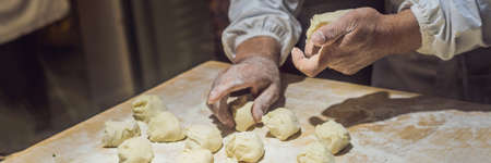 Chinese chef making dumplings in the kitchenの写真素材