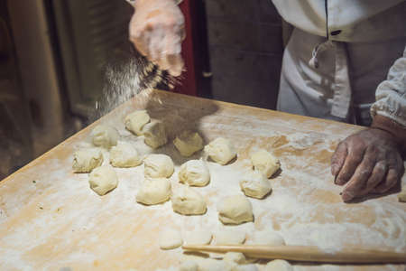 Chinese chef making dumplings in the kitchen.の写真素材