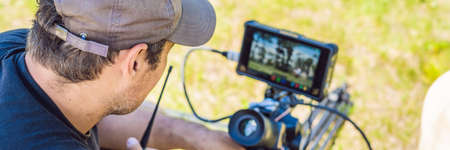 Shooting process on cinema stage - commercial production set, exterior location.Profeccional cameraman operates the camera. BANNER, LONG FORMATの写真素材