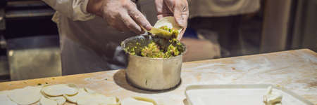 Chinese chef making dumplings in the kitchenの写真素材