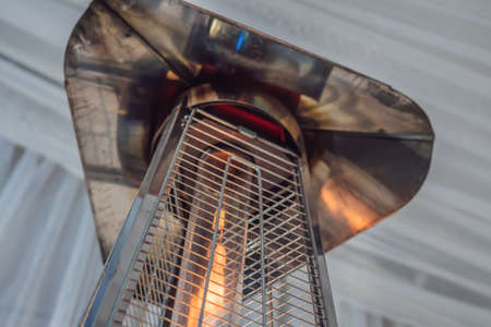 heating lamp heater placed among the tables of an open cafeの写真素材
